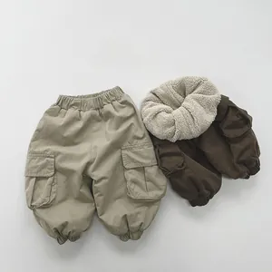 Detail of warm fleece lining and durable cargo pockets on khaki boys trousers
