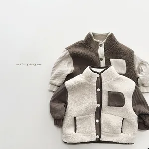 Close-up of color-block sherpa fleece jacket with ribbed knit sleeves and button details