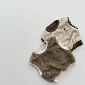 Close-up of fleece pet vest with warm vibes embroidery and contrast patchwork texture