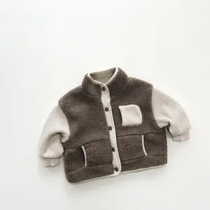 Close-up of boys thick fleece jacket with contrast color sleeves and soft texture