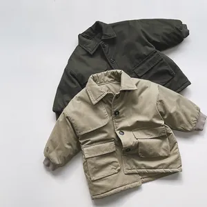 Detail of kids winter cotton jackets in olive green and khaki with utility pockets