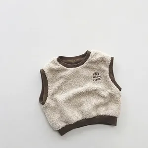Detailed view of color-block sherpa fleece vest with warm vibes embroidery and contrast trim