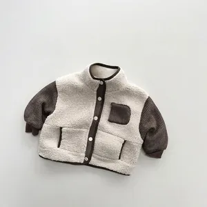 Close-up of kids contrast color fleece jacket with warm lamb wool and brown sleeves