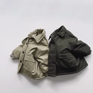 Detail of padded winter coats for kids with large pockets and ribbed cuffs
