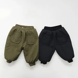 Detail view of windproof quilted thick warm winter pants for children in army green and black