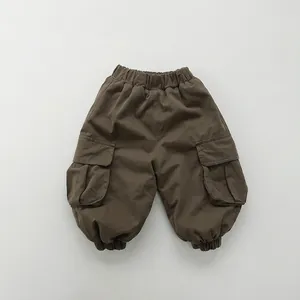 Detailed view of kids dark brown cargo pants with elastic waist and side flap pockets