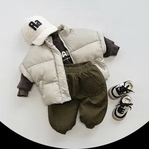 Kids winter outfit set featuring beige vest brown sweatshirt and olive green pants
