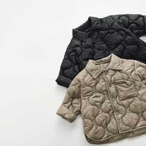 Detailed view of onion-quilted kids padded jackets with snap buttons and turn-down collars