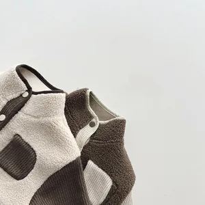 Detail of kids fuzzy fleece jackets with color contrast pockets and premium buttons