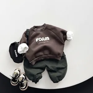 Kids warm winter set featuring brown sweatshirt and dark green fleece cargo pants