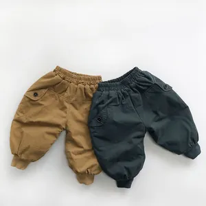 Detailed view of elastic high waist and ribbed cuffs on kids warm cargo pants