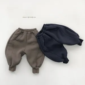 Detail view of warm brown and navy blue fleece-lined thermal jogger pants for kids