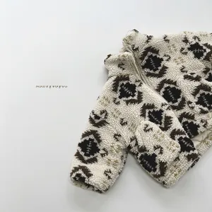 Close-up of kids sherpa fleece jacket with ethnic pattern and smooth front zipper