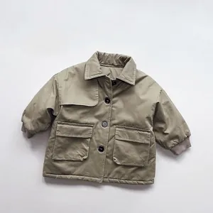 Detailed close-up of army green kids padded coat featuring lapel and large flap pockets