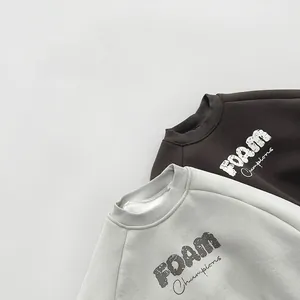 Detail view of ribbed necklines and FOAM Champions print on fleece sweatshirts