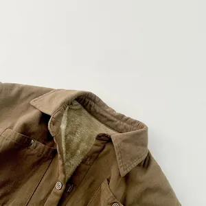 Détail d'une veste marron pour enfant avec doublure épaisse en polaire sherpa blanche