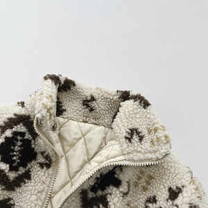 Close-up of kids warm sherpa jacket collar featuring leopard spots and quilted lining