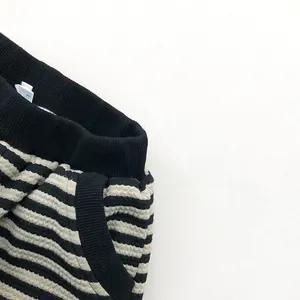 Close-up of kids striped fleece pants showing waffle texture and elastic waistband
