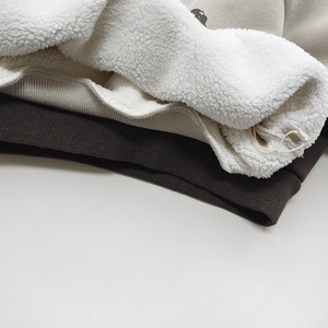 Close-up of kids fleece sweatshirt with soft lamb wool lining and ribbed cuffs detail