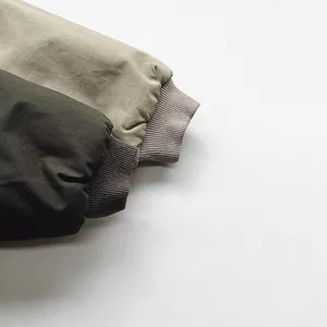 Detail shot of windproof ribbed cuffs on olive and khaki winter jackets for children