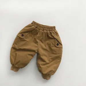Detail view of children's thick fleece-lined joggers with elastic waist and cargo pockets