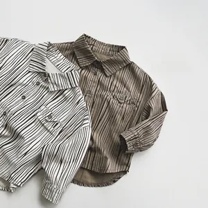 Flat lay of cotton vertical striped long-sleeve shirts with front pocket for kids
