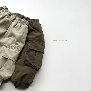 Flat lay detail of beige and coffee cargo pants with elastic waist and side pockets