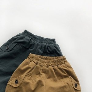 Detail of elastic waist and cargo pockets on warm winter fleece-lined kids pants