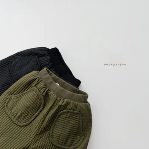 Close-up of quilted texture and elastic waist detail on padded thermal kids trousers
