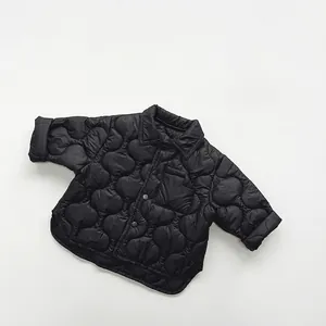 Close-up of black quilted children cotton shirt with snap buttons and shirt collar detail