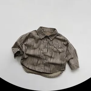 Detailed flat lay of children's vintage brown striped cotton shirt with button pocket