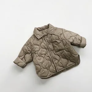 Detail of olive green kids quilted cotton jacket with onion stitching and buttons