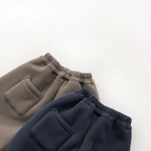 Detail view of elastic waist and back pocket on thickened fleece-lined casual sweatpants
