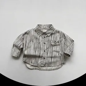 Detail of children's vertical stripe shirt featuring soft cotton fabric and chest pocket