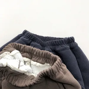 Fleece-lined kids casual trousers in navy and brown with warm sherpa interior