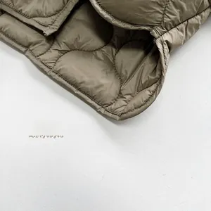 Detailed macro view of diamond-quilted pattern on warm olive green padded shirt for kids