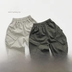 Flat lay of kids loose cargo pants in khaki and dark charcoal grey with flap pockets