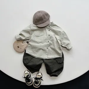 Flat lay of boys vintage earth-tone cargo pants set with shirt, bag and sneakers