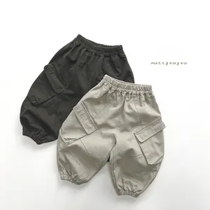 Detail of elastic waist and functional cargo pockets on stylish kids' utility trousers