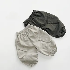 Detailed close-up of cotton cargo pants featuring elastic waist and large side utility pockets
