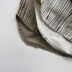 Close-up of brown and beige vertical stripes on soft cotton children's shirt fabric