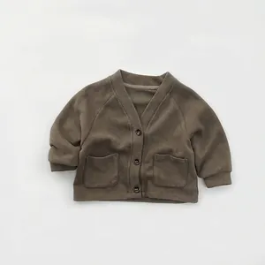 Close-up of olive green kids knit cardigan showing V-neck, buttons and fabric texture