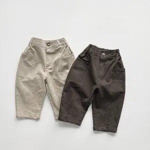Detail of elastic waist and twill fabric on khaki and brown children's casual trousers