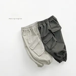 Laid flat cargo pants for kids in beige and dark grey with elastic waist and side pockets