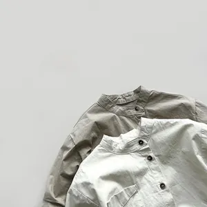 Detail of mandarin collar and button placket on cotton linen shirts for kids