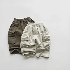 Flat lay detail of kids cargo pants with elastic waist and large flap pockets