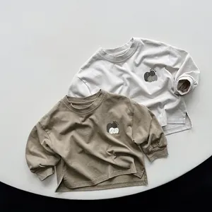 Detail of cotton kids long sleeve tees with side slits and round neck in two colors
