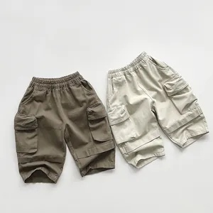 Detail view of kids cargo pants in brown and cream with elastic waist and side pockets