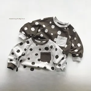 Detail of Korean style long-sleeved polka dot sweatshirts for kids with rib cuffs and pockets