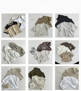 Flat lay of Korean style cotton children's clothing set with neutral earth tones